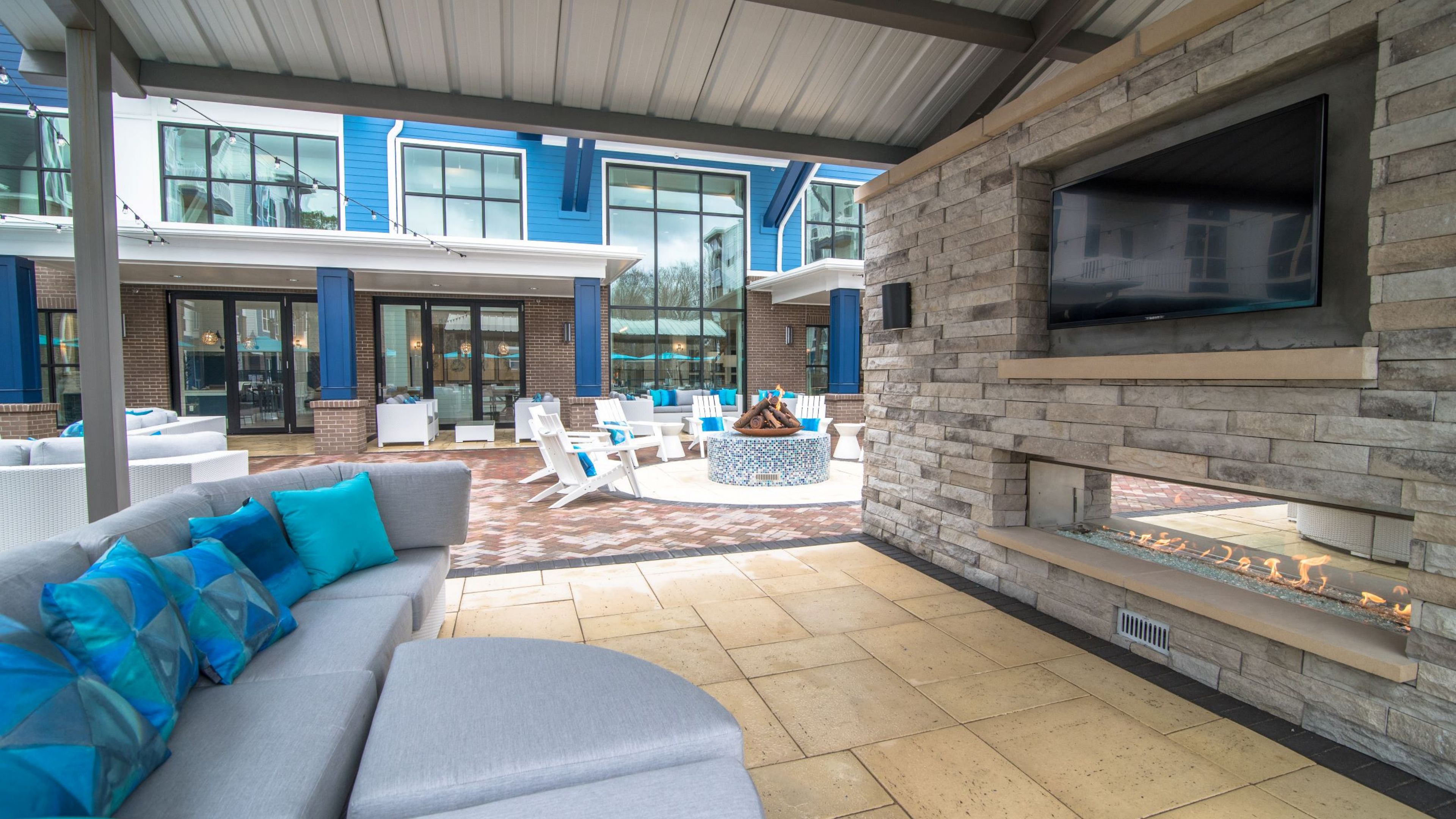 Hawthorne at Indy West outdoor courtyard with lounge area with fireplace and large screen TV